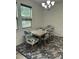 Dining area features a modern chandelier, dining table, and window with natural light at 425 Liberty Hill, Morrisville, NC 27560