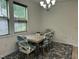 A dining room featuring a contemporary chandelier, patterned chairs, and a table set for a cozy meal at 425 Liberty Hill, Morrisville, NC 27560