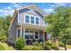 Charming two-story home with a cozy front porch swing and beautiful landscaping at 425 Liberty Hill, Morrisville, NC 27560