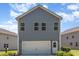 Home exterior featuring gray siding, white trim and a two car garage at 425 Liberty Hill, Morrisville, NC 27560