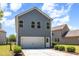 Rear exterior view featuring gray siding, white trim and a two car garage at 425 Liberty Hill, Morrisville, NC 27560