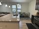 Kitchen featuring granite countertops and stainless sink with dining space in the background at 425 Liberty Hill, Morrisville, NC 27560
