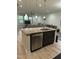 Bright kitchen island featuring granite countertops and stainless steel dishwasher, and open-concept design at 425 Liberty Hill, Morrisville, NC 27560