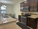 Spacious kitchen showcasing granite counters, stainless appliances, and an adjacent dining area for gatherings at 425 Liberty Hill, Morrisville, NC 27560