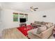Bright living room with light hardwood floors, large windows, and comfortable seating at 425 Liberty Hill, Morrisville, NC 27560