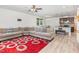 Spacious living room with hardwood floors, large sectional, and a modern ceiling fan at 425 Liberty Hill, Morrisville, NC 27560