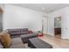 Cozy living room featuring a gray couch, wooden floors and neutral paint at 425 Liberty Hill, Morrisville, NC 27560