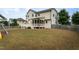 Expansive backyard with deck, screened porch, and partial fencing, ideal for outdoor activities at 453 Granite Saddle Dr, Rolesville, NC 27571
