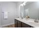 Dual sinks and mirrors outfit this bathroom with modern wood cabinetry at 453 Granite Saddle Dr, Rolesville, NC 27571