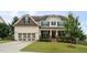 Charming two-story home with a covered porch, manicured lawn, and attached two-car garage at 453 Granite Saddle Dr, Rolesville, NC 27571