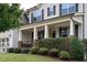 Charming home with a welcoming front porch featuring stone accents and manicured landscaping at 453 Granite Saddle Dr, Rolesville, NC 27571