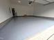 Clean, finished garage with epoxy flooring providing a functional space for parking and storage at 453 Granite Saddle Dr, Rolesville, NC 27571