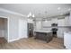 Spacious kitchen with white cabinets, stainless steel appliances, large island, and wood-look flooring at 453 Granite Saddle Dr, Rolesville, NC 27571