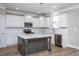 Modern kitchen with stainless appliances, white cabinetry, pendant lighting, and an island at 453 Granite Saddle Dr, Rolesville, NC 27571