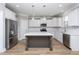 Beautiful kitchen featuring recessed lighting, white cabinets, stainless steel appliances, and gray center island at 453 Granite Saddle Dr, Rolesville, NC 27571