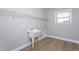 A laundry room sink and shelf with vinyl flooring offers easy cleanup at 453 Granite Saddle Dr, Rolesville, NC 27571