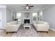 Bright living room with a fireplace, white sofas, and a light-colored rug at 453 Granite Saddle Dr, Rolesville, NC 27571