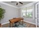 Comfortable office space featuring a dark wood desk, bright window, and stylish area rug, perfect for a productive workspace at 453 Granite Saddle Dr, Rolesville, NC 27571