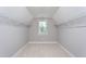 Spacious walk-in closet featuring ample shelving and a bright window, perfect for organization at 453 Granite Saddle Dr, Rolesville, NC 27571