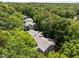 Aerial view of gray apartment buildings tucked away in a dense tree canopy at 4631 Timbermill Ct # 203, Raleigh, NC 27612