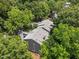 Gray apartment buildings with surrounding lush green trees viewed from the air at 4631 Timbermill Ct # 203, Raleigh, NC 27612