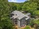 Aerial view of gray apartment building surrounded by trees and vegetation at 4631 Timbermill Ct # 203, Raleigh, NC 27612