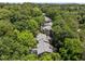 Gray apartment building exterior from the air with surrounding lush green trees at 4631 Timbermill Ct # 203, Raleigh, NC 27612