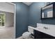 Cozy bathroom featuring blue accent wall, tiled floors, and a white vanity at 4631 Timbermill Ct # 203, Raleigh, NC 27612