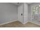 Entryway with vinyl flooring, a white entry door, and a large window with blinds at 4631 Timbermill Ct # 203, Raleigh, NC 27612