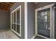 An exterior of the condo with large windows and a door with the unit number on it at 4631 Timbermill Ct # 203, Raleigh, NC 27612