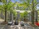 Apartment complex with gray siding, ample parking, and mature trees at 4631 Timbermill Ct # 203, Raleigh, NC 27612