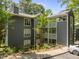Three story condo complex with gray siding and white trim at 4631 Timbermill Ct # 203, Raleigh, NC 27612