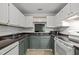 Functional kitchen with white appliances, white subway tile, and two-tone cabinets at 4631 Timbermill Ct # 203, Raleigh, NC 27612