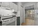 Bright kitchen featuring white cabinets and an adjoining dining area with natural light at 4631 Timbermill Ct # 203, Raleigh, NC 27612