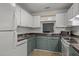 Charming kitchen with white cabinets, tiled backsplash, and modern appliances at 4631 Timbermill Ct # 203, Raleigh, NC 27612
