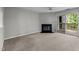 Bright living room with fireplace, deck access, and a ceiling fan at 4631 Timbermill Ct # 203, Raleigh, NC 27612