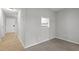 Neutral living room with view into kitchen and entry door at 4631 Timbermill Ct # 203, Raleigh, NC 27612