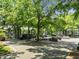 Community parking lot with spots available, surrounded by mature trees and apartment buildings at 4631 Timbermill Ct # 203, Raleigh, NC 27612