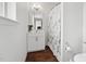 Bright bathroom with wood floors, white cabinets, granite vanity, and shower with decorative floral curtain at 475 Long View Dr, Franklinton, NC 27525