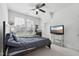 Neutral-toned bedroom featuring carpet, ceiling fan, large window, and TV at 475 Long View Dr, Franklinton, NC 27525