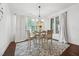 Bright dining area features a modern chandelier, hardwood floors, patterned rug and ample natural light at 475 Long View Dr, Franklinton, NC 27525