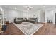 Spacious living room featuring hardwood floors, a cozy sectional, and a decorative accent wall at 475 Long View Dr, Franklinton, NC 27525