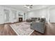 Bright living room with a fireplace, large sectional, and hardwood floors throughout the space at 475 Long View Dr, Franklinton, NC 27525