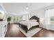 Expansive main bedroom with hardwood floors, large windows and a sitting area with sofa at 475 Long View Dr, Franklinton, NC 27525