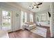 Bright sun room with hardwood floors, ceiling fan and ample windows with scenic views at 475 Long View Dr, Franklinton, NC 27525
