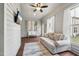 Bright sun room with hardwood floors, ceiling fan, ample windows, and comfortable sofa at 475 Long View Dr, Franklinton, NC 27525