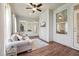Bright sun room with hardwood floors, ceiling fan, ample windows, and comfortable sofa at 475 Long View Dr, Franklinton, NC 27525