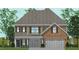 Charming two-story home featuring a brick facade, symmetrical windows and shutter accents, with a gray roof at 50 Guardian St, Youngsville, NC 27596