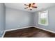 Bright bedroom with ceiling fan, hardwood floors, and a window at 5016 Dawn Piper Dr, Raleigh, NC 27613