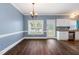Cozy dining area with hardwood floors, a modern chandelier, and access to the kitchen at 5016 Dawn Piper Dr, Raleigh, NC 27613